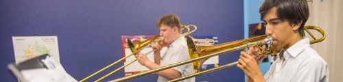 students playing trombones